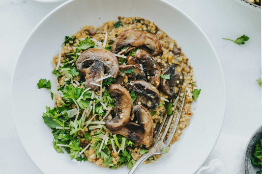 A white plate with buckwheat and mushroom risotto